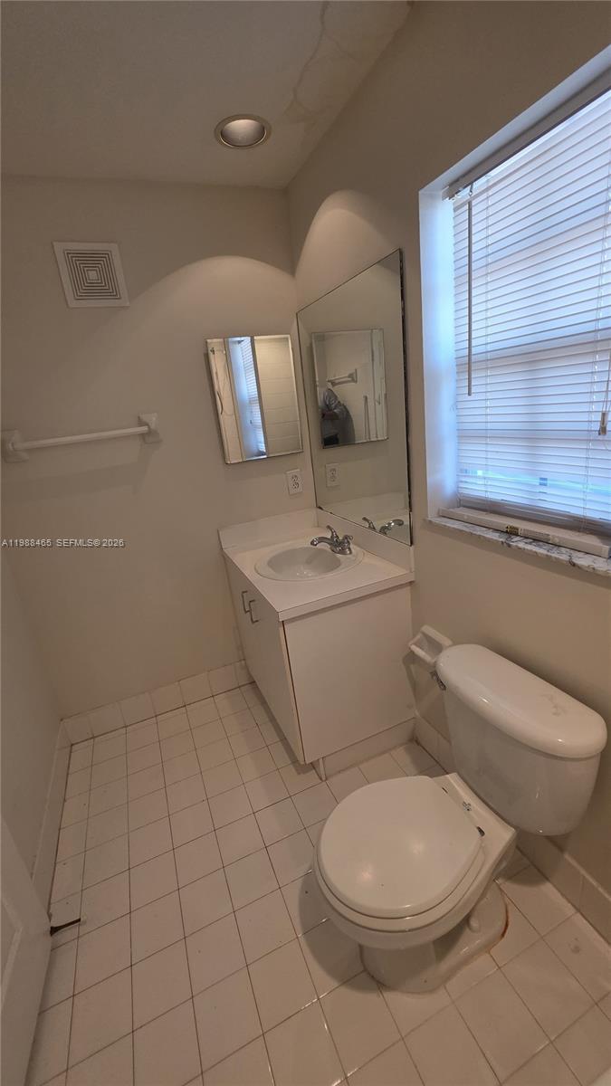 18741 Southwest 25th Court Miramar, FL 33029 - Photo 31 of 32 a white toilet sitting next to a bathroom sink