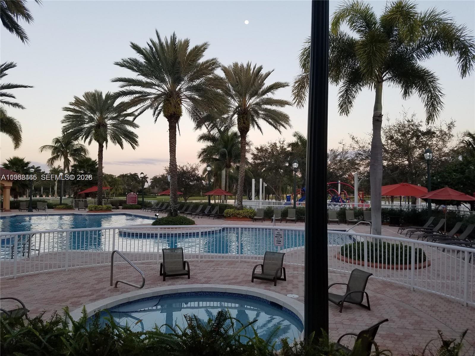 18741 Southwest 25th Court Miramar, FL 33029 - Photo 4 of 32 a view of a lake with palm trees