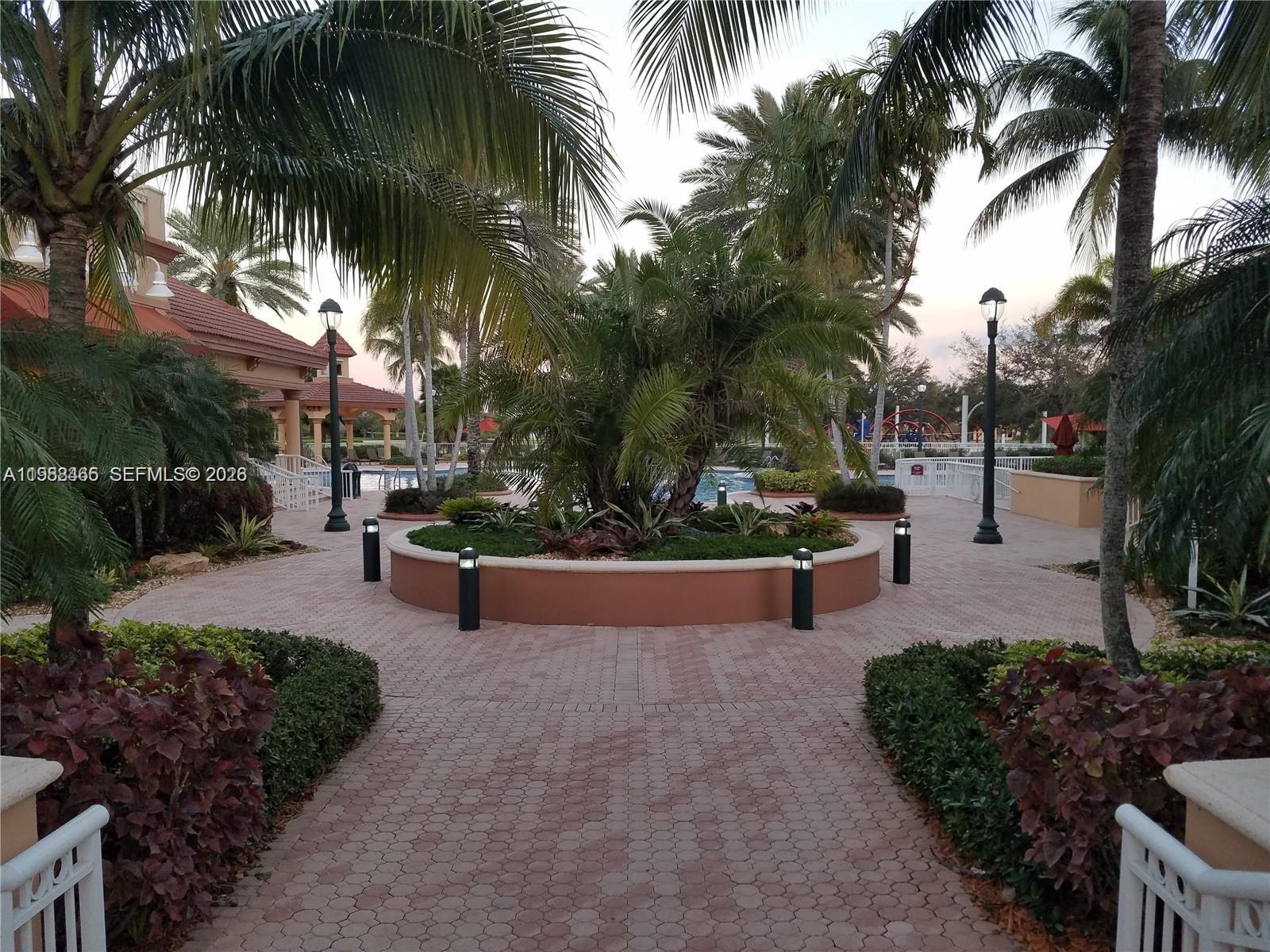 18741 Southwest 25th Court Miramar, FL 33029 - Photo 8 of 32 a park bench sitting in the middle of a park