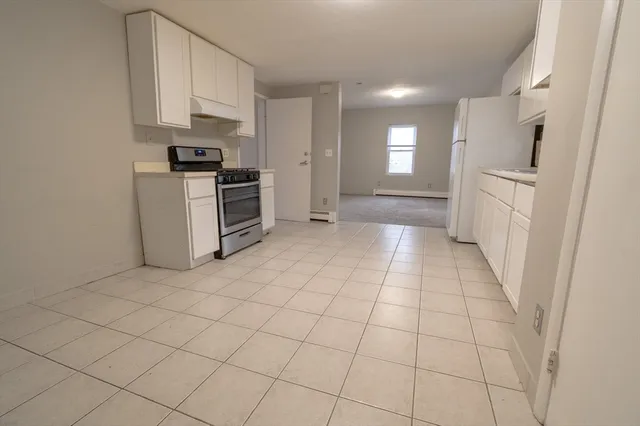 a kitchen with stainless steel appliances a refrigerator and a stove top oven