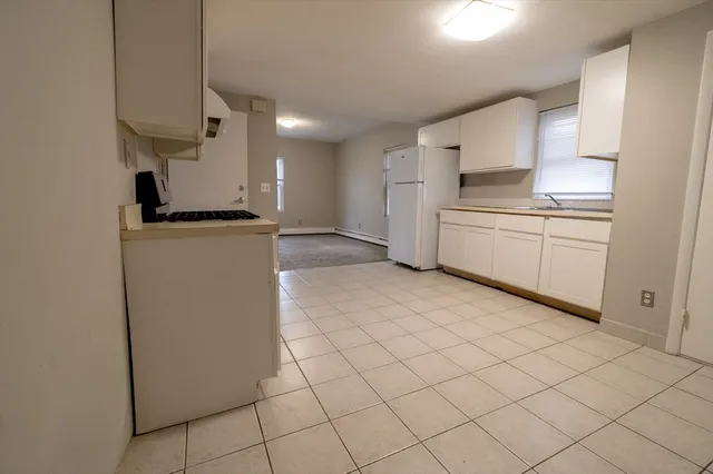 a kitchen with stainless steel appliances a refrigerator sink and cabinets