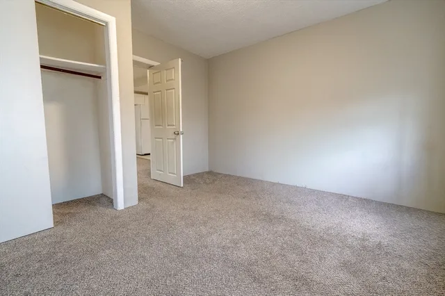 an empty room with closet area