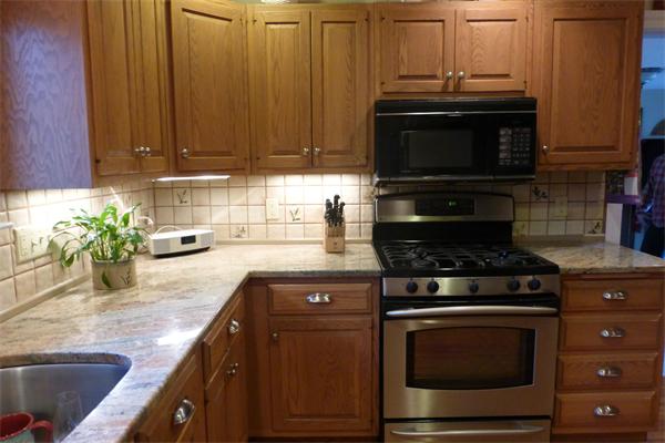 305 Sterling Road Lancaster, MA 01523 - Photo 5 of 21 a kitchen with granite countertop a stove and a sink