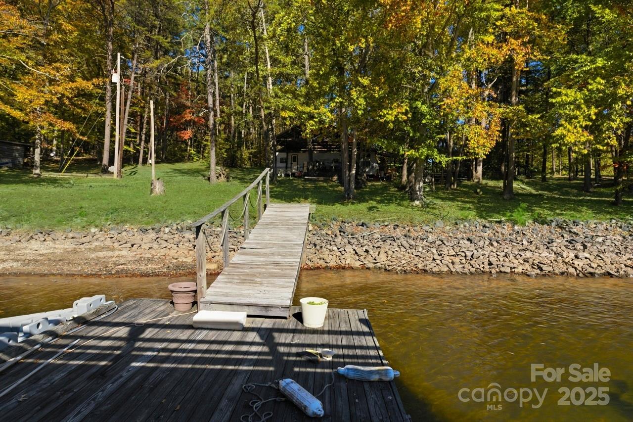 8825 Holdsclaw Road Terrell, NC 28682 - Photo 11 of 33 a view of a lake with a bench next to a yard