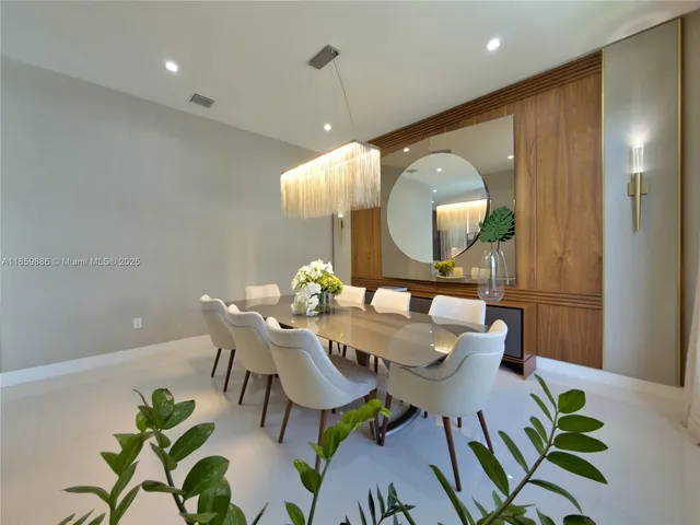 a kitchen with stainless steel appliances kitchen island granite countertop a sink and a refrigerator