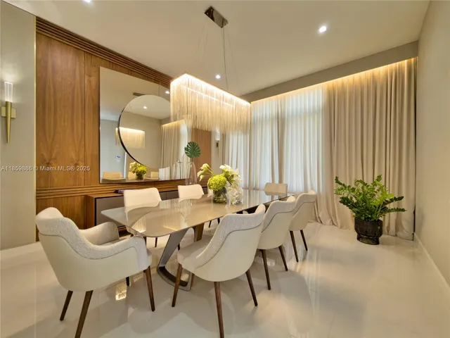 a kitchen with stainless steel appliances kitchen island granite countertop a sink and a refrigerator