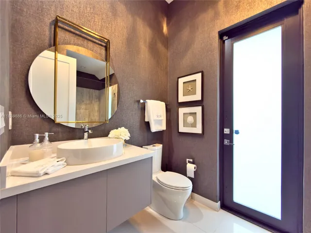 a view of a patio with couches table and chairs potted plants and palm tree