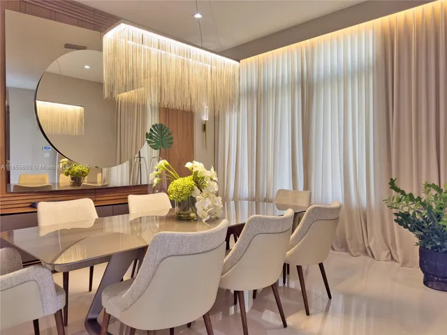 a view of a patio with couches table and chairs potted plants and palm tree