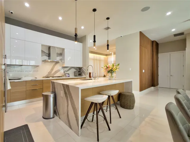 a view of a patio with table and chairs potted plants and large tree
