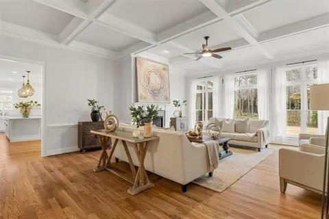 a kitchen with stainless steel appliances granite countertop a refrigerator a stove and a wooden floors