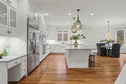 a bathroom with a granite countertop toilet and a sink