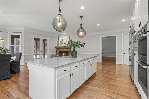 a spacious bedroom with a bed and ceiling fan