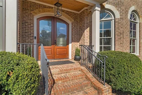 front view of a brick house with a large window