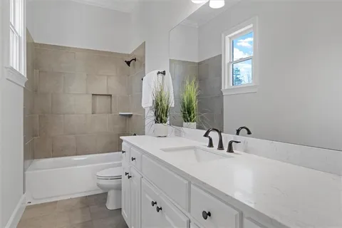 an empty room with windows and ceiling fan