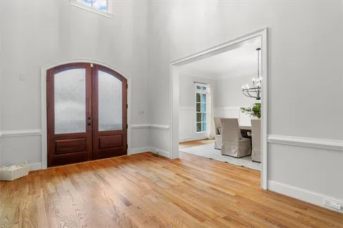 a view of a dining room with furniture wooden floor and chandelier