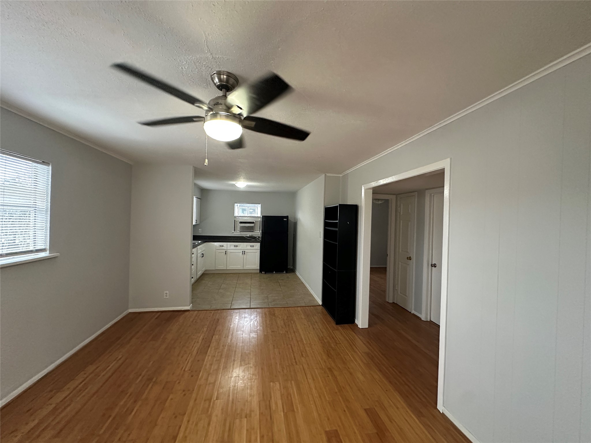 4911 Delano Street, Unit 2 Houston, TX 77004 - Photo 3 of 13 a view of empty room with wooden floor and fan
