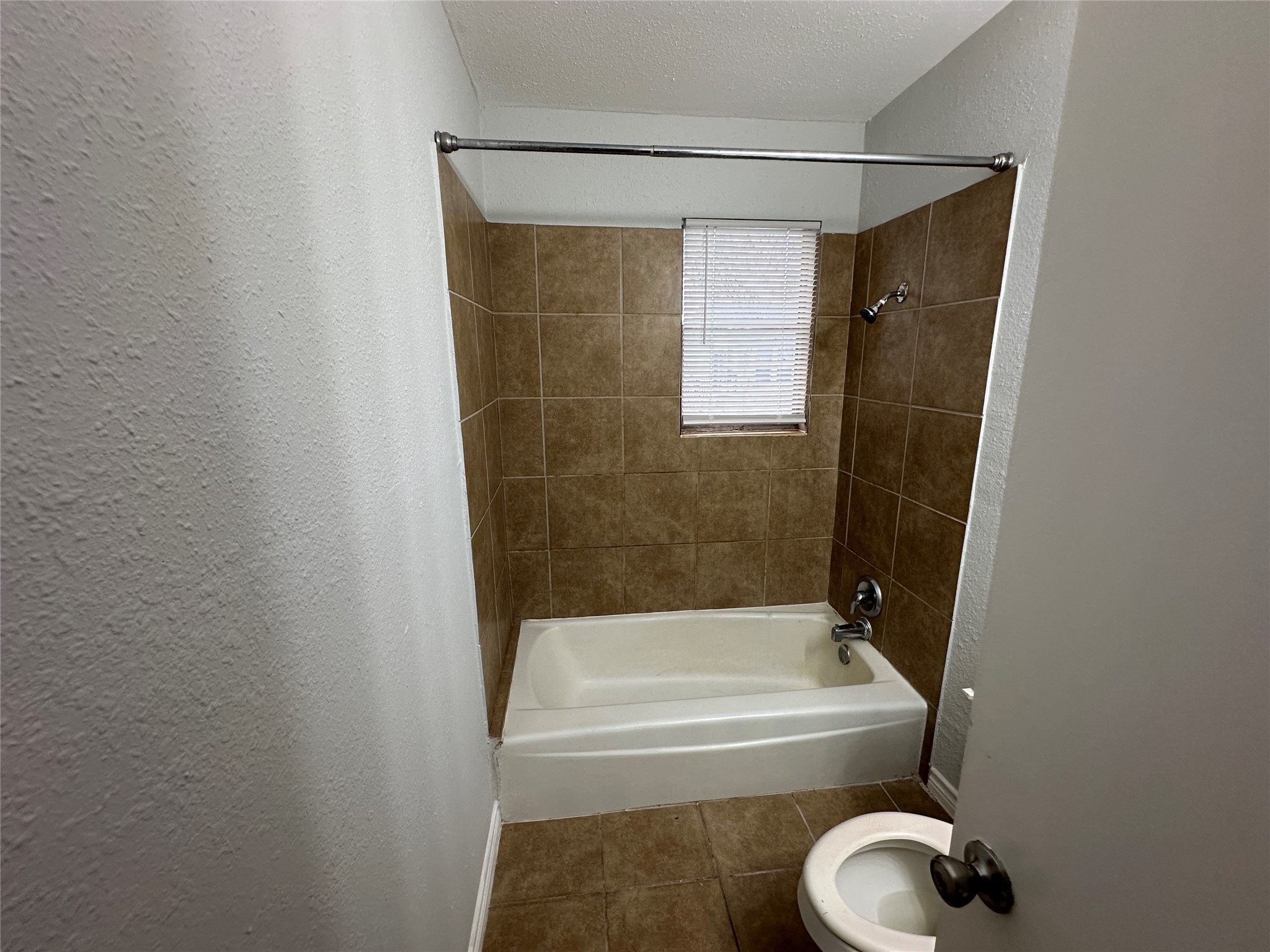 4911 Delano Street, Unit 2 Houston, TX 77004 - Photo 5 of 13 a bathroom with a shower and bathtub