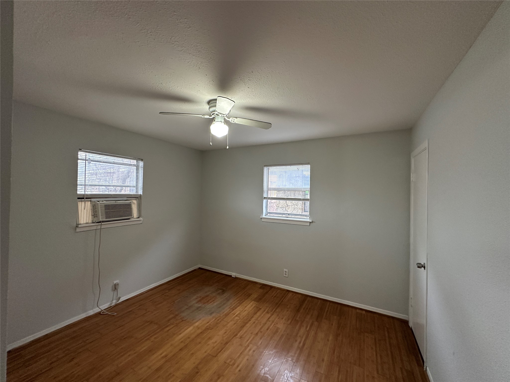 4911 Delano Street, Unit 2 Houston, TX 77004 - Photo 8 of 13 a view of an empty room with wooden floor and a window