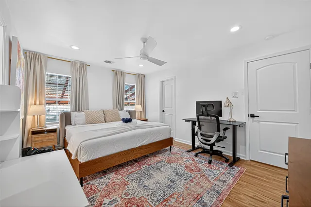 a bedroom with a bed and a chair in it