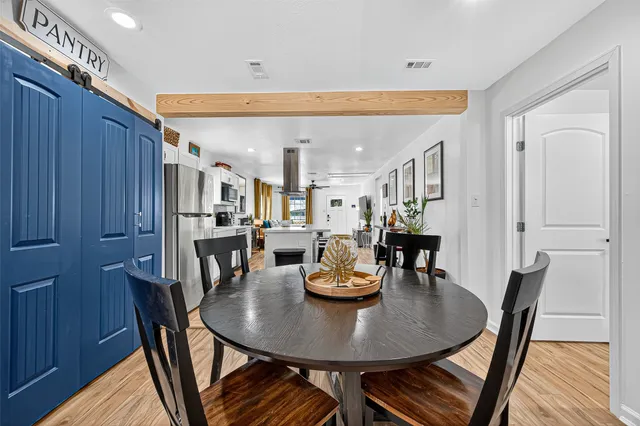 a dining room with furniture and wooden floor