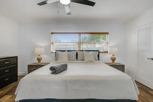 a bedroom with a bed and window