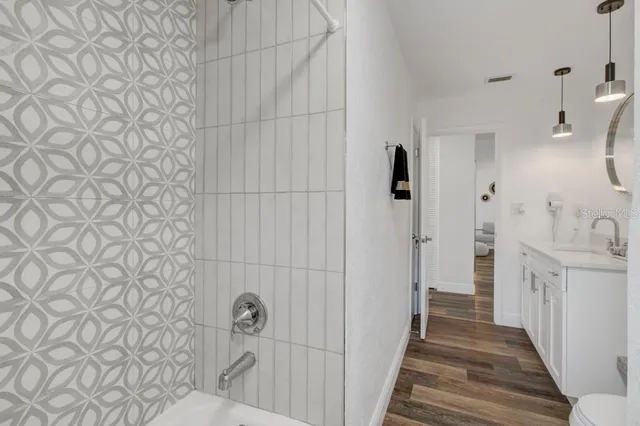 a bathroom with a sink and shower