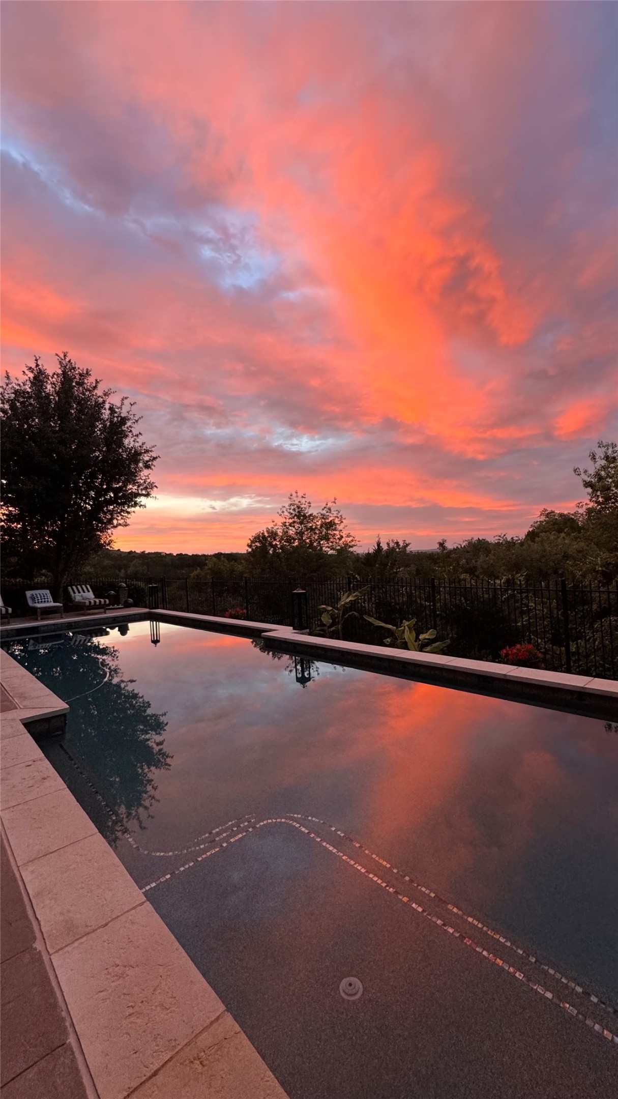 2312 Rivina Drive Austin, TX 78733 - Photo 6 of 40 Expansive outdoor pool with stone coping and a dark aggregate finish