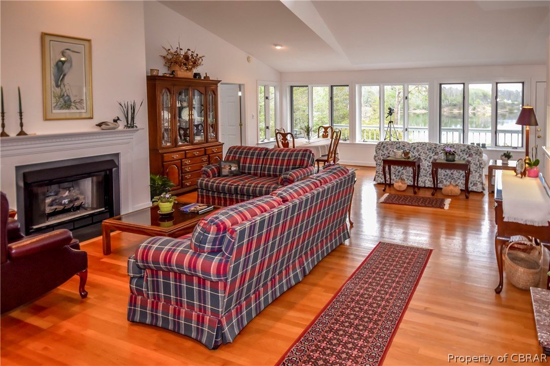 1959 Western Branch Road Lancaster, VA 22503 - Photo 10 of 49 Great Room with hardwood floors, gas log fireplace, vaulted ceiling.