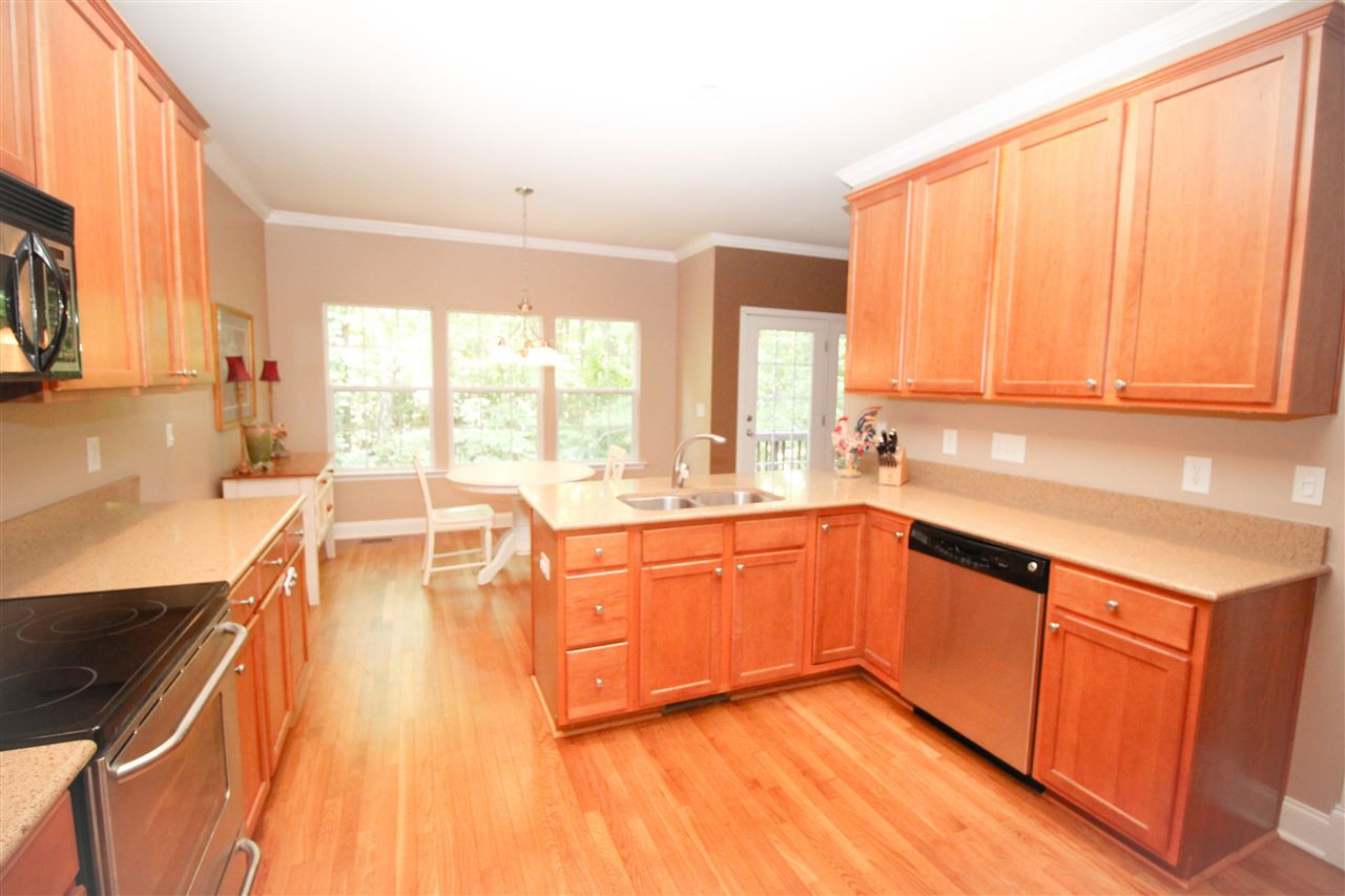 201 Riley Oaks Lane Apex, NC 27539 - Photo 8 of 29 Ample cabinetry and storage space in this kitchen open to eat-in breakfast nook! Kitchen