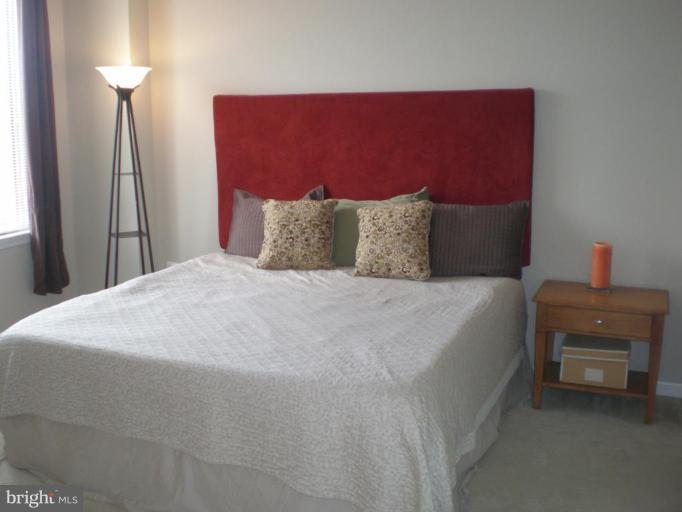 11710 Old Georgetown Road, Unit 408 Rockville, MD 20852 - Photo 12 of 27 a bedroom with a bed and a couch