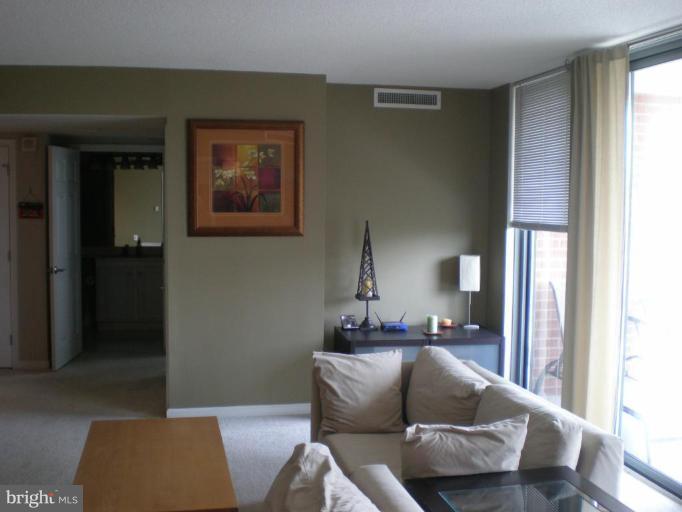 11710 Old Georgetown Road, Unit 408 Rockville, MD 20852 - Photo 13 of 27 a living room with furniture and a window