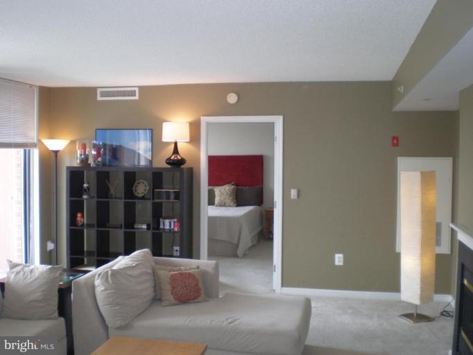 11710 Old Georgetown Road, Unit 408 Rockville, MD 20852 - Photo 14 of 27 a living room with furniture and a ceiling fan