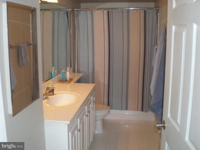 11710 Old Georgetown Road, Unit 408 Rockville, MD 20852 - Photo 3 of 27 a en suite bathroom with a sink a toilet and shower