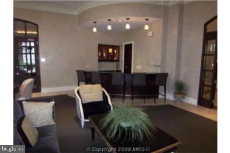 11710 Old Georgetown Road, Unit 408 Rockville, MD 20852 - Photo 21 of 27 a dining room with furniture and wooden floor