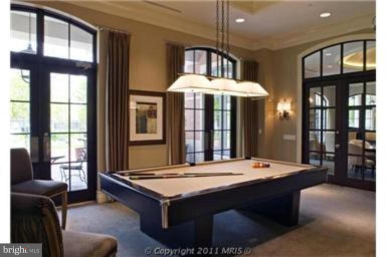 11710 Old Georgetown Road, Unit 408 Rockville, MD 20852 - Photo 23 of 27 a living room with furniture pool table and a large window
