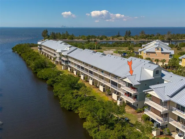 an aerial view of a house with a yard and lake view