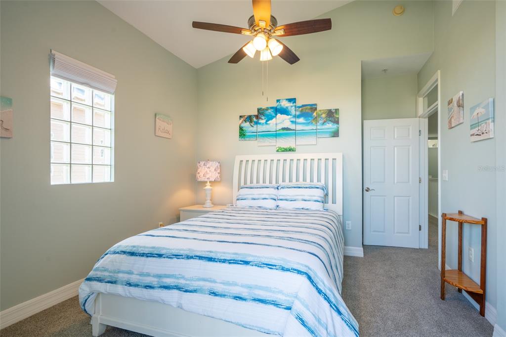 3230 Mangrove Point Drive Ruskin, FL 33570 - Photo 27 of 44 a bedroom with a bed and a chandelier