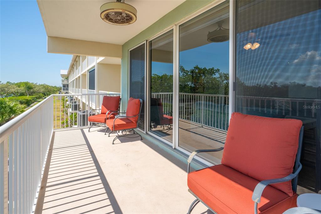 3230 Mangrove Point Drive Ruskin, FL 33570 - Photo 10 of 44 a balcony with wooden floor table and chairs