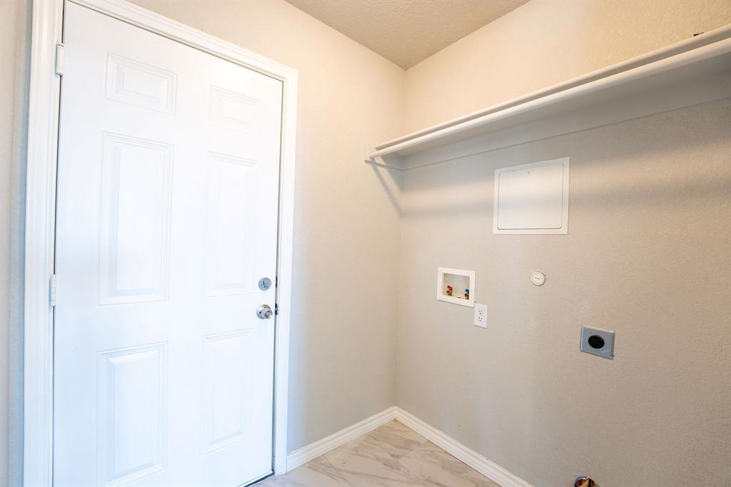 1020 Springview Lane Mabank, TX 75147 - Photo 13 of 15 Laundry room with electric dryer hookup, hookup for a gas dryer, hookup for a washing machine, and light marble finish flooring