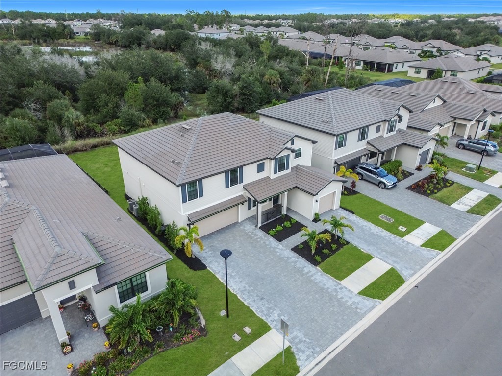 an aerial view of multiple houses with a yard