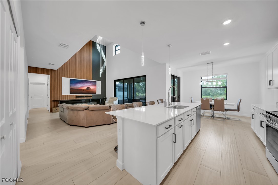 11264 Canopy Loop Fort Myers, FL 33913 - Photo 16 of 49 a large white kitchen with sink stove and living room