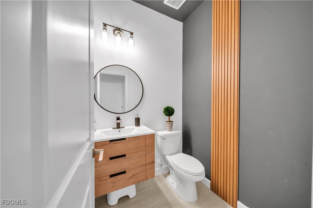 11264 Canopy Loop Fort Myers, FL 33913 - Photo 21 of 49 a bathroom with a sink mirror vanity and toilet