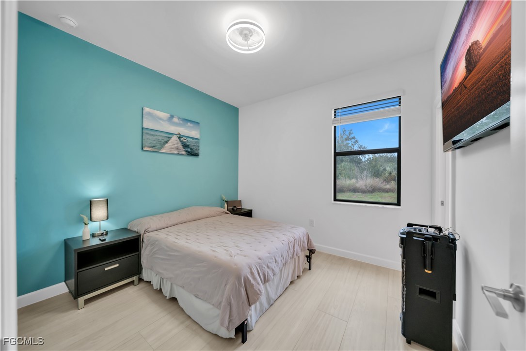 11264 Canopy Loop Fort Myers, FL 33913 - Photo 23 of 49 a bedroom with a bed and a painting on the wall