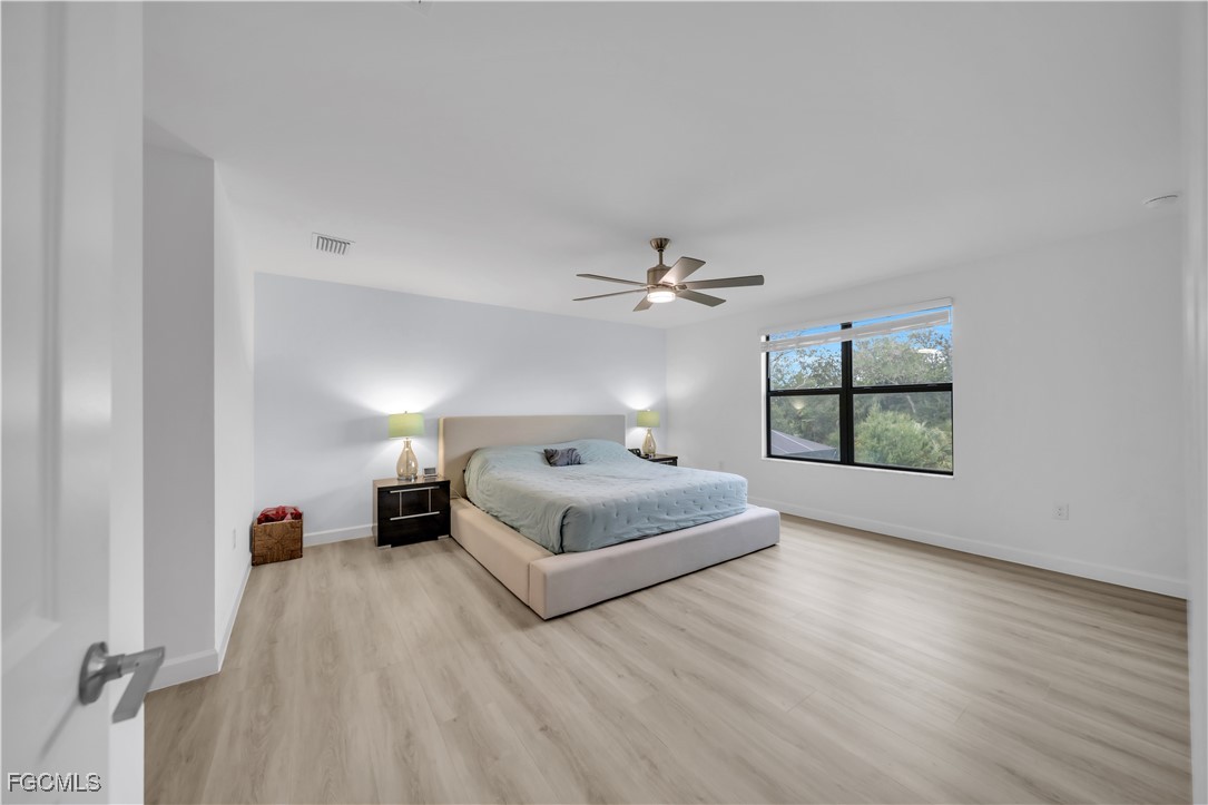 11264 Canopy Loop Fort Myers, FL 33913 - Photo 29 of 49 a spacious bedroom with a bed and a window