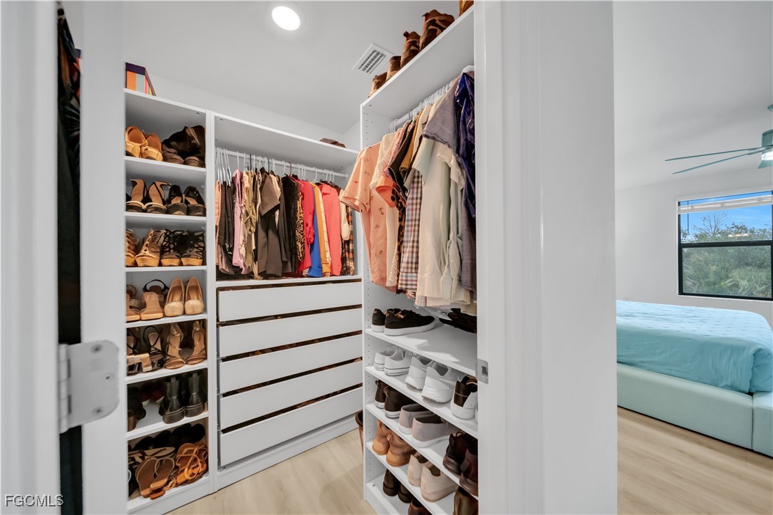 11264 Canopy Loop Fort Myers, FL 33913 - Photo 31 of 49 a view of walk in closet with clothes and shoes