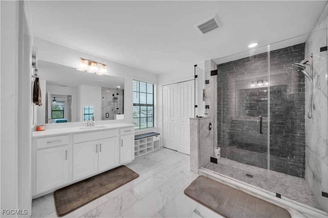 11264 Canopy Loop Fort Myers, FL 33913 - Photo 33 of 49 a bathroom with a shower sink and mirror