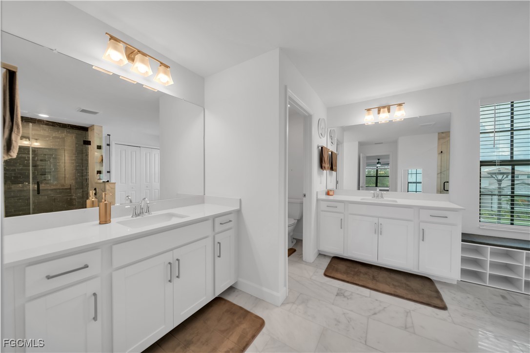 11264 Canopy Loop Fort Myers, FL 33913 - Photo 34 of 49 a bathroom with a double vanity sink and mirror