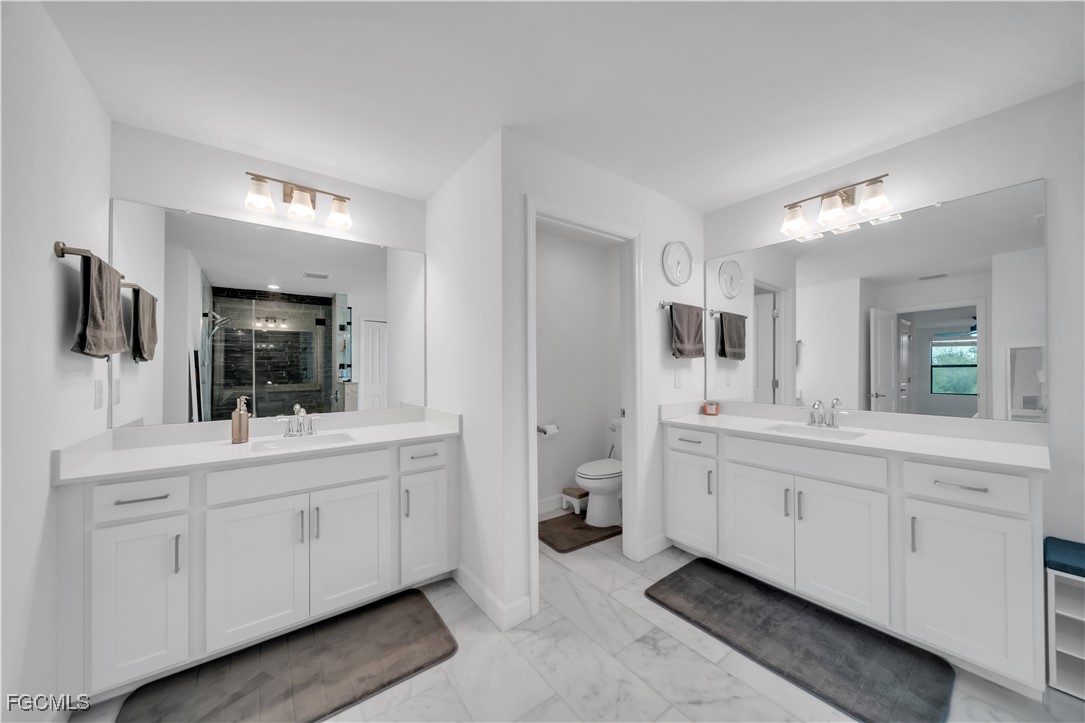 11264 Canopy Loop Fort Myers, FL 33913 - Photo 35 of 49 a bathroom with a double vanity sink and mirror
