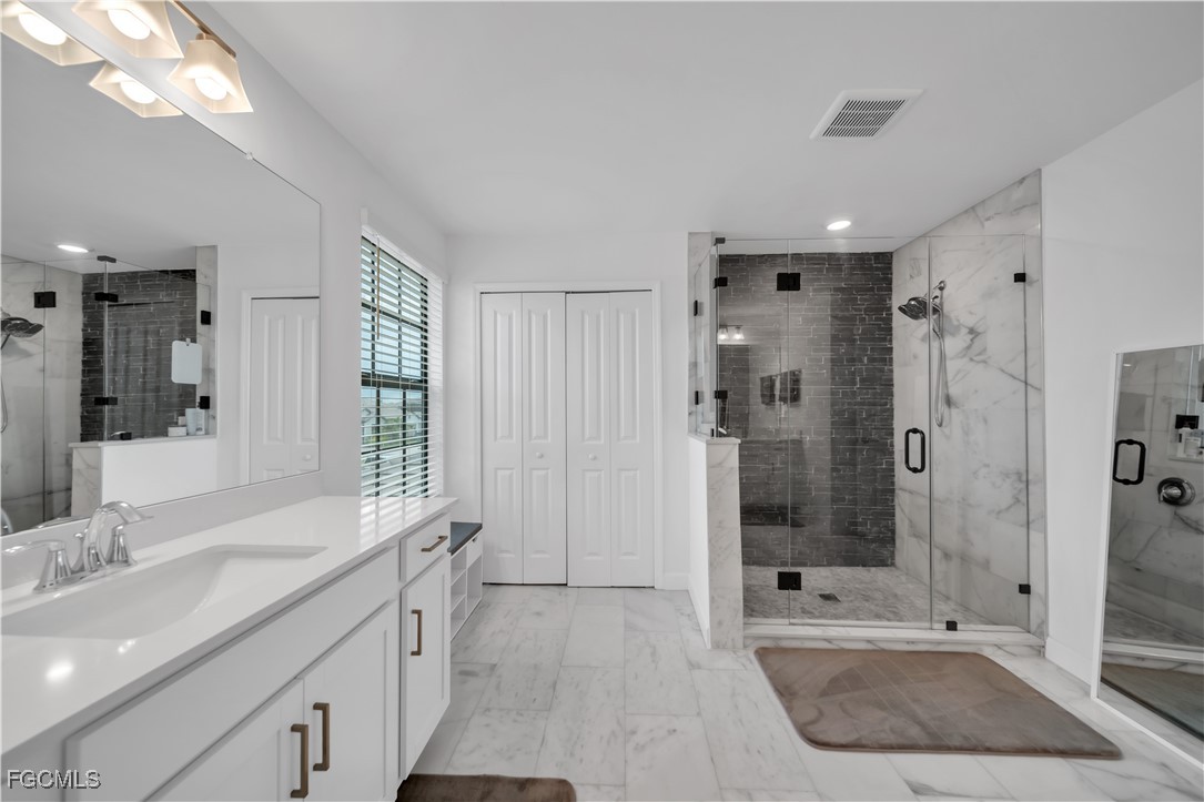 11264 Canopy Loop Fort Myers, FL 33913 - Photo 36 of 49 a spacious bathroom with a shower sink and mirror
