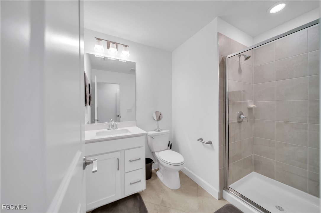 11264 Canopy Loop Fort Myers, FL 33913 - Photo 39 of 49 a bathroom with a toilet a sink and shower